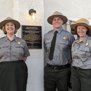 Poppie Gullett dressed in park ranger attire with two colleagues