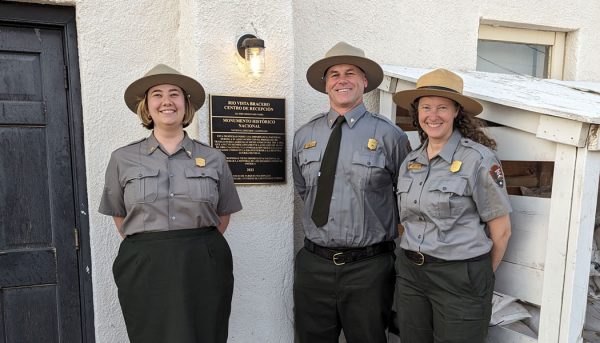 Poppie Gullett dressed in park ranger attire with two colleagues