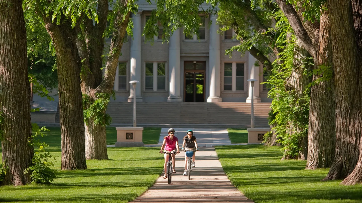 Two people riding bikes through the oval