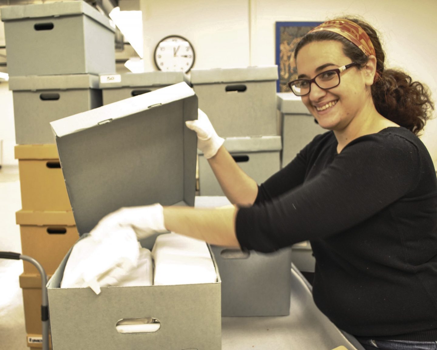 Student filing things away into a box